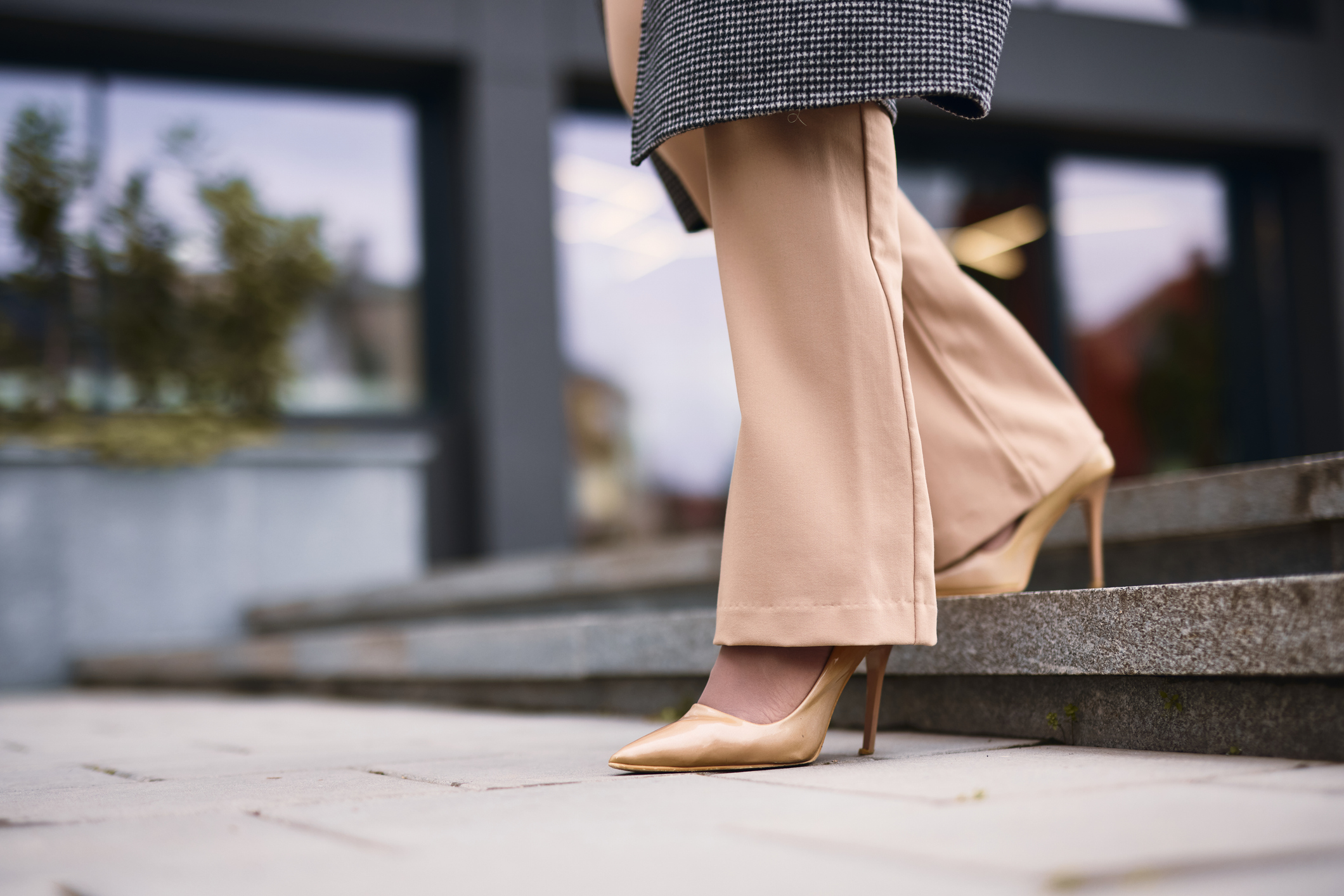 close up of nude heels walking down stairs