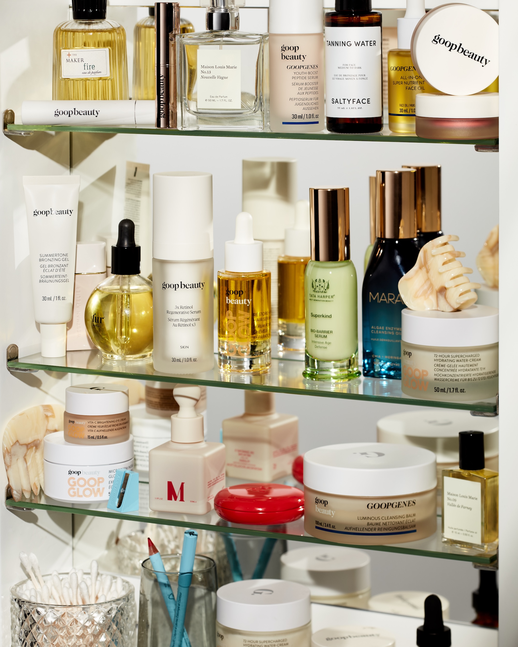 Skincare from Goop arranged in a medicine cabinet.