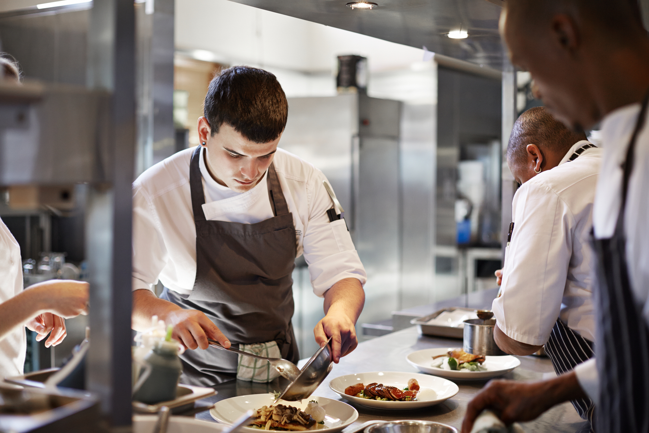 Chefs preparing dishes in a restaurant.