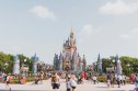 A family stands in front of Cinderella's Castle in Walt Disney World.