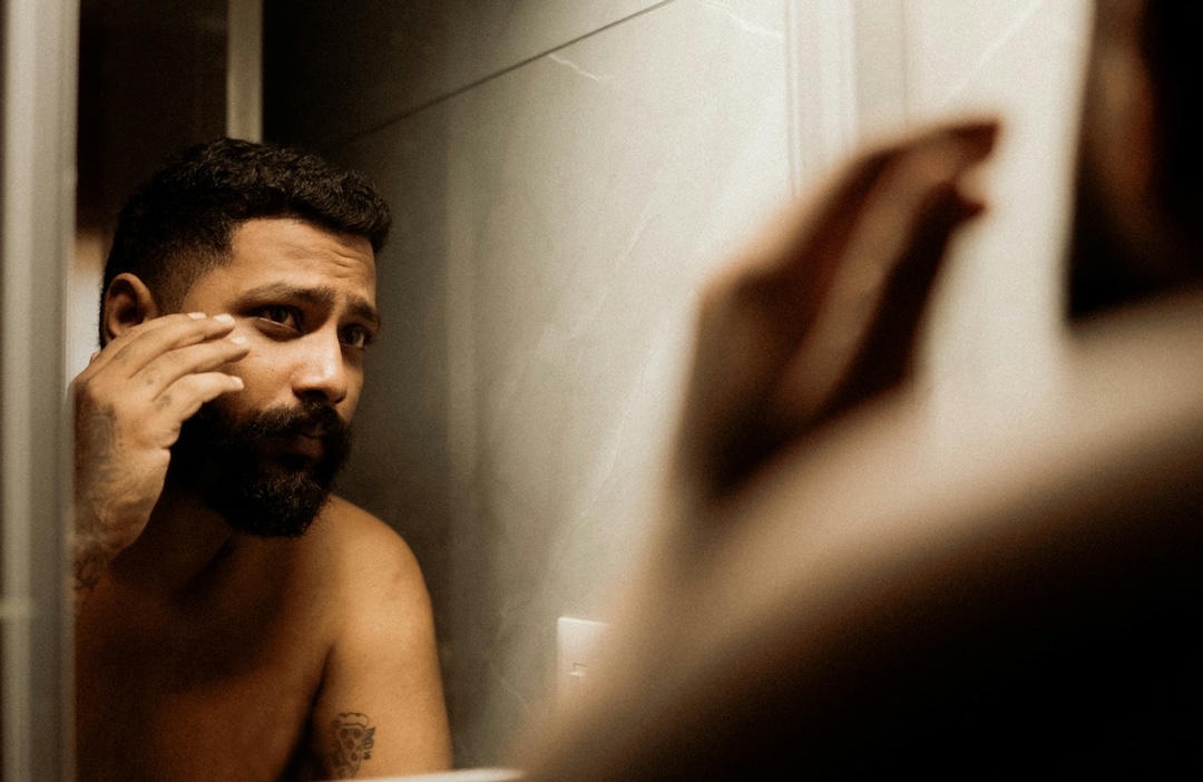 Man grooming his face with a beard trimmer