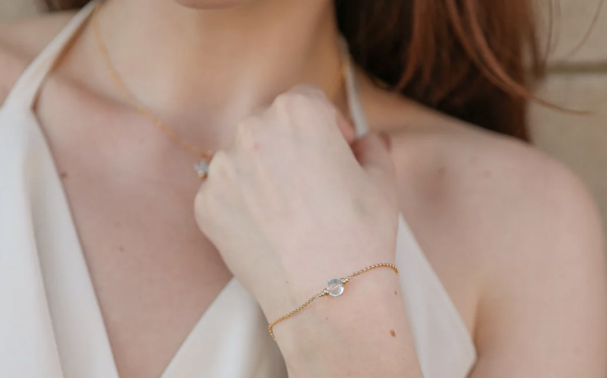 A woman modeling birthstone jewelry from Workshop Underground.