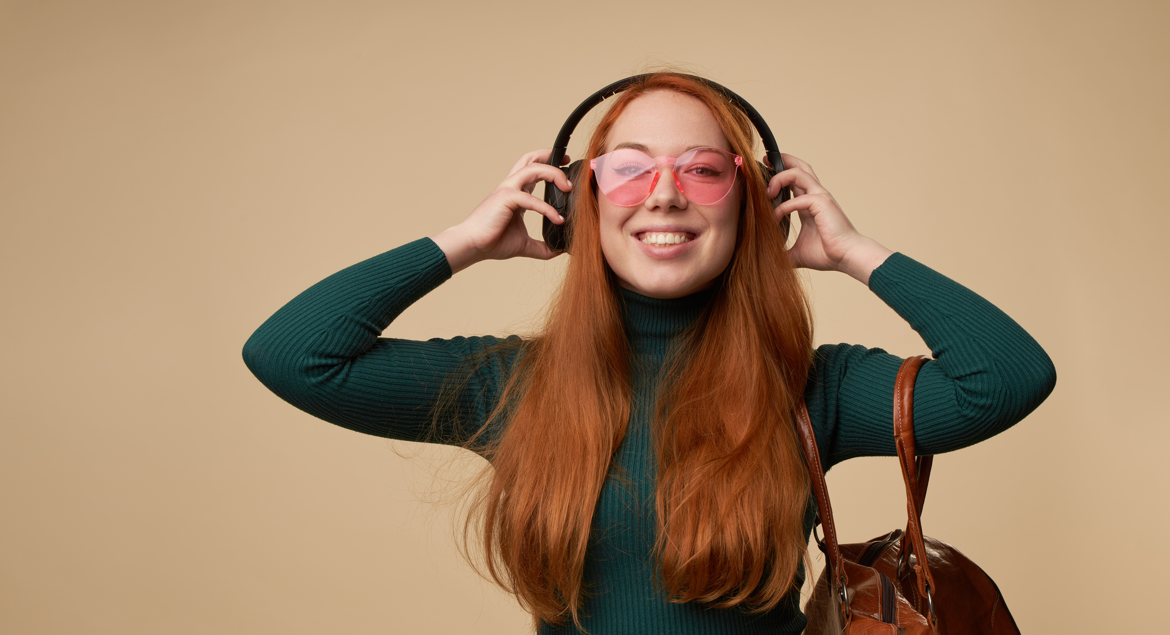 Happy young woman with wireless headphones