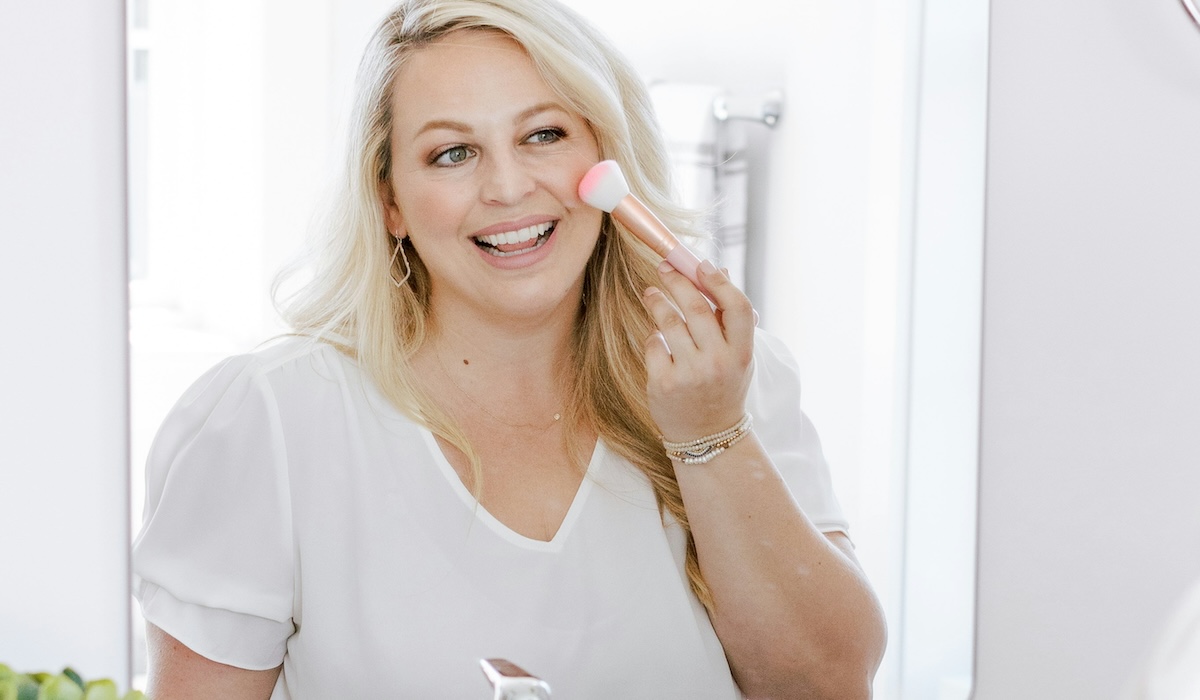 Woman applying makeup from Charlotte Tilbury's Labor Day sale