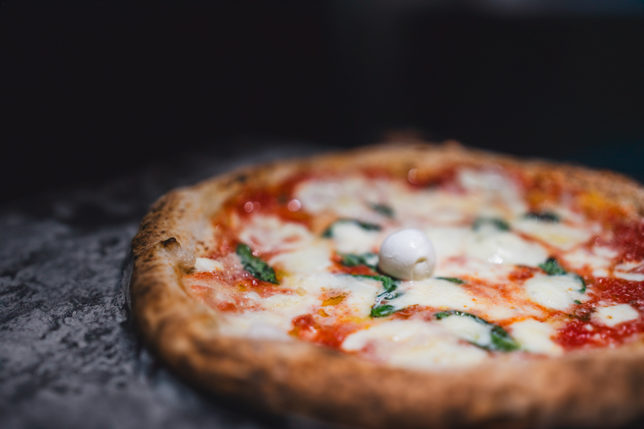 Original Pizza Margherita in a traditional Pizzeria, Naples, Italy.