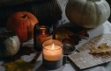 Fall candles on a table with pumpkins