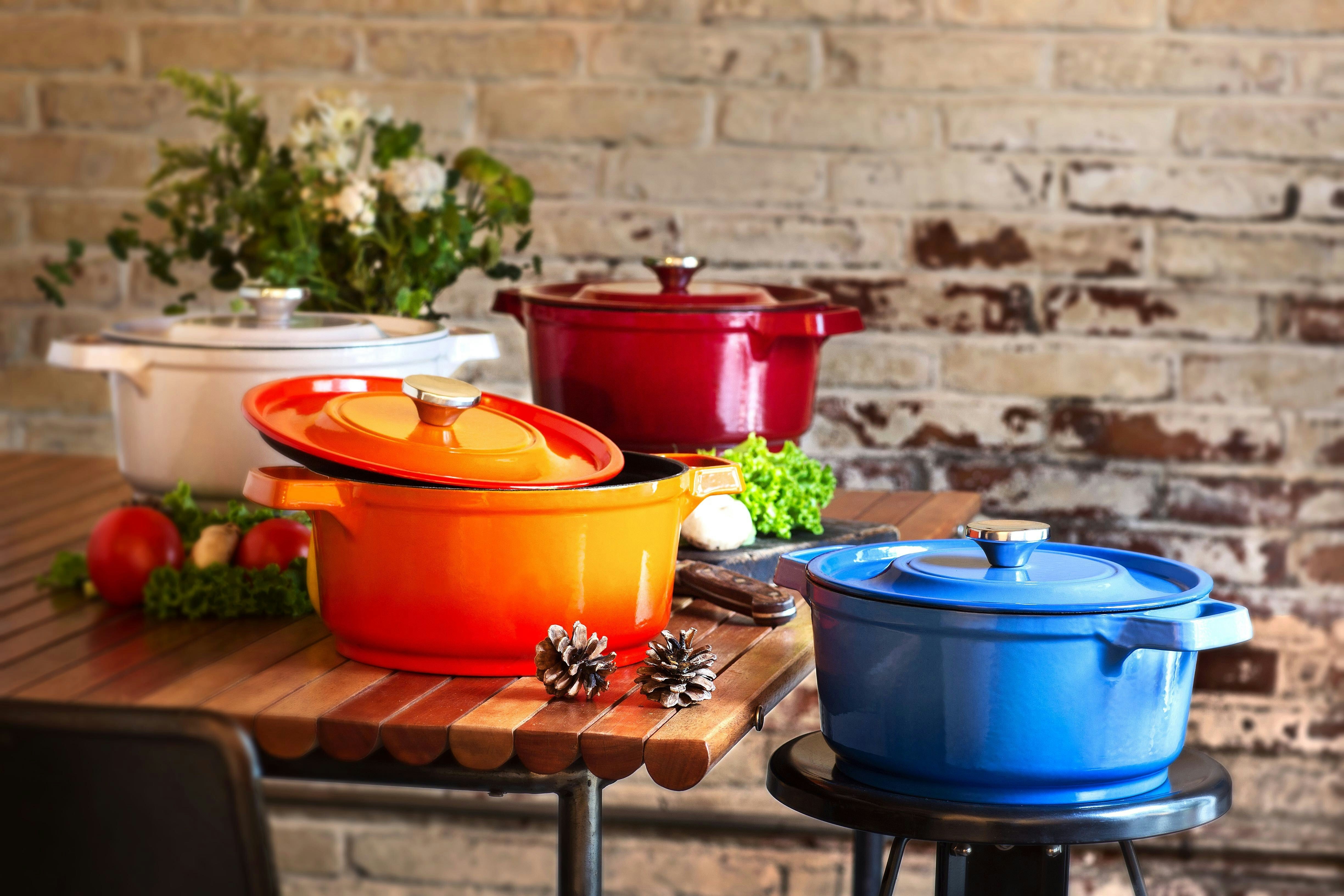 A kitchen with a colorful array of Dutch Oven Cast Iron pots.