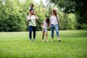 Family walking in the park with dad wearing cool sneakers.