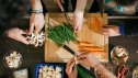 People prepping fresh vegetables in a bright kitchen