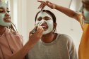 Women applying face masks in the bathroom