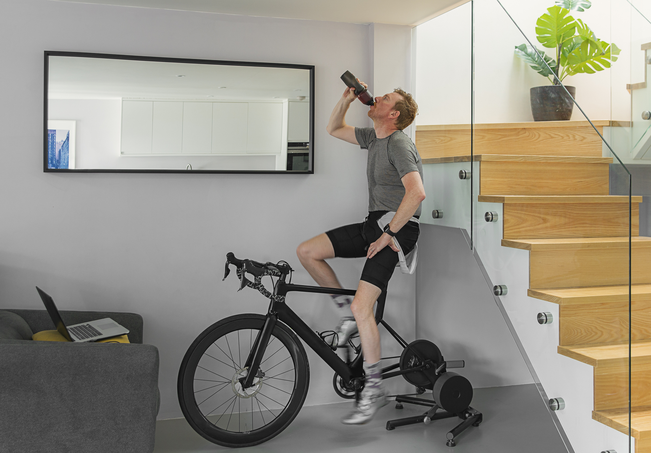 Man on his turbo trainer at home.