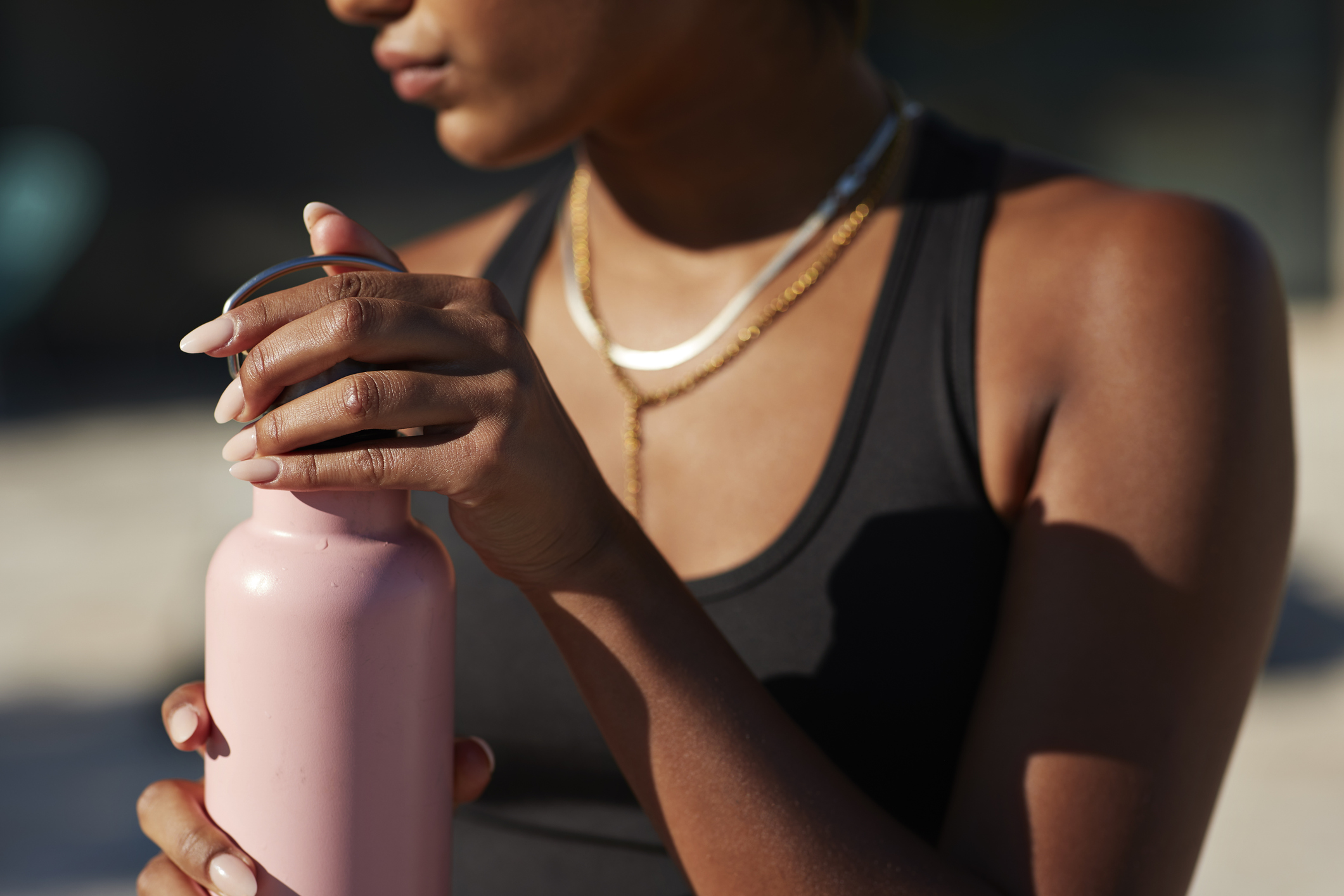 Woman opening pink water bottle