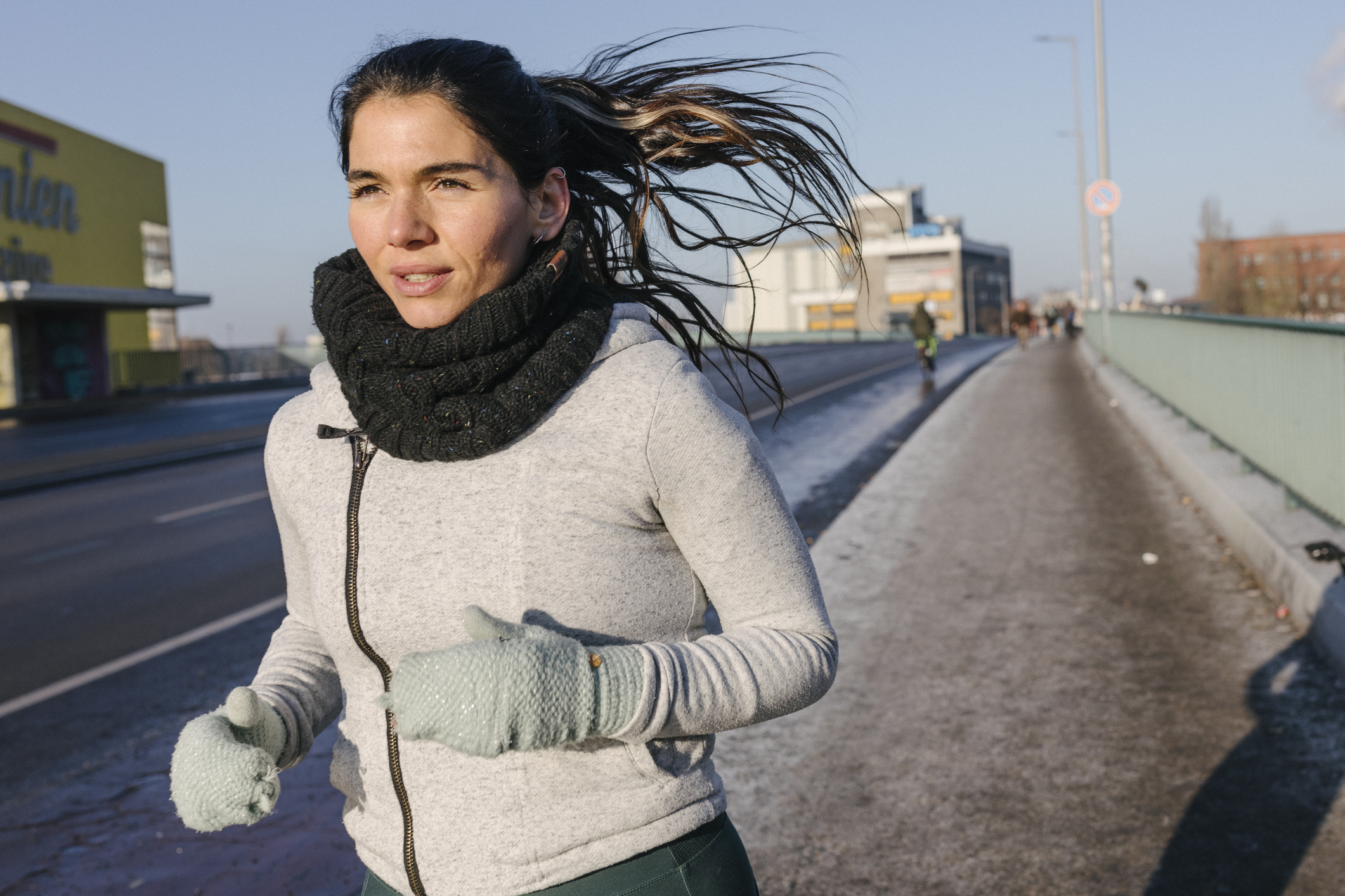 Wist up shot of Hispanic woman going for a run on a freezing winter's day.