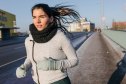 Wist up shot of Hispanic woman going for a run on a freezing winter's day.