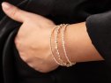 A bracelet with precious stones on a girl's hand.