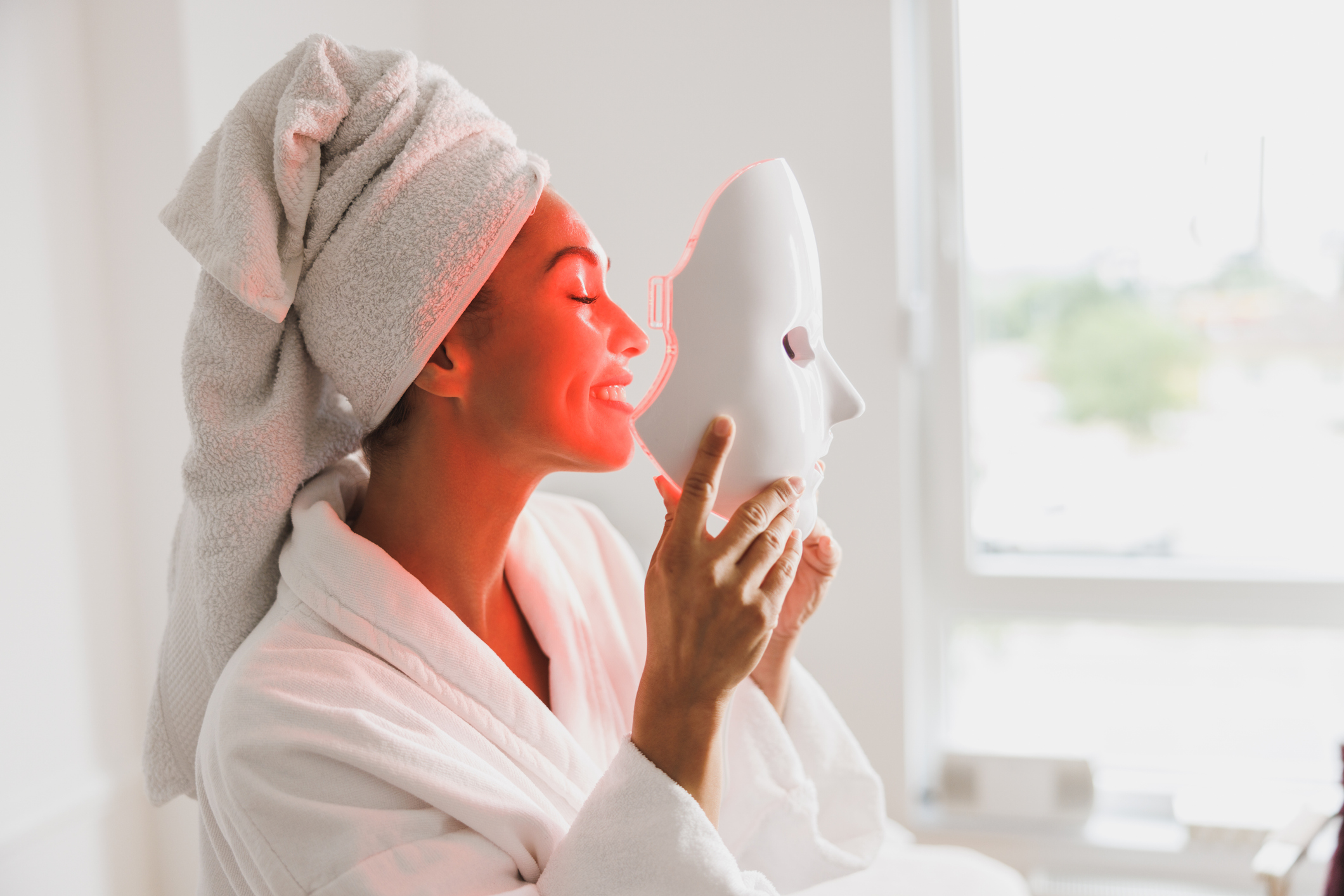 Woman Getting an LED Light Facial Mask Treatment At The Beauty Salon