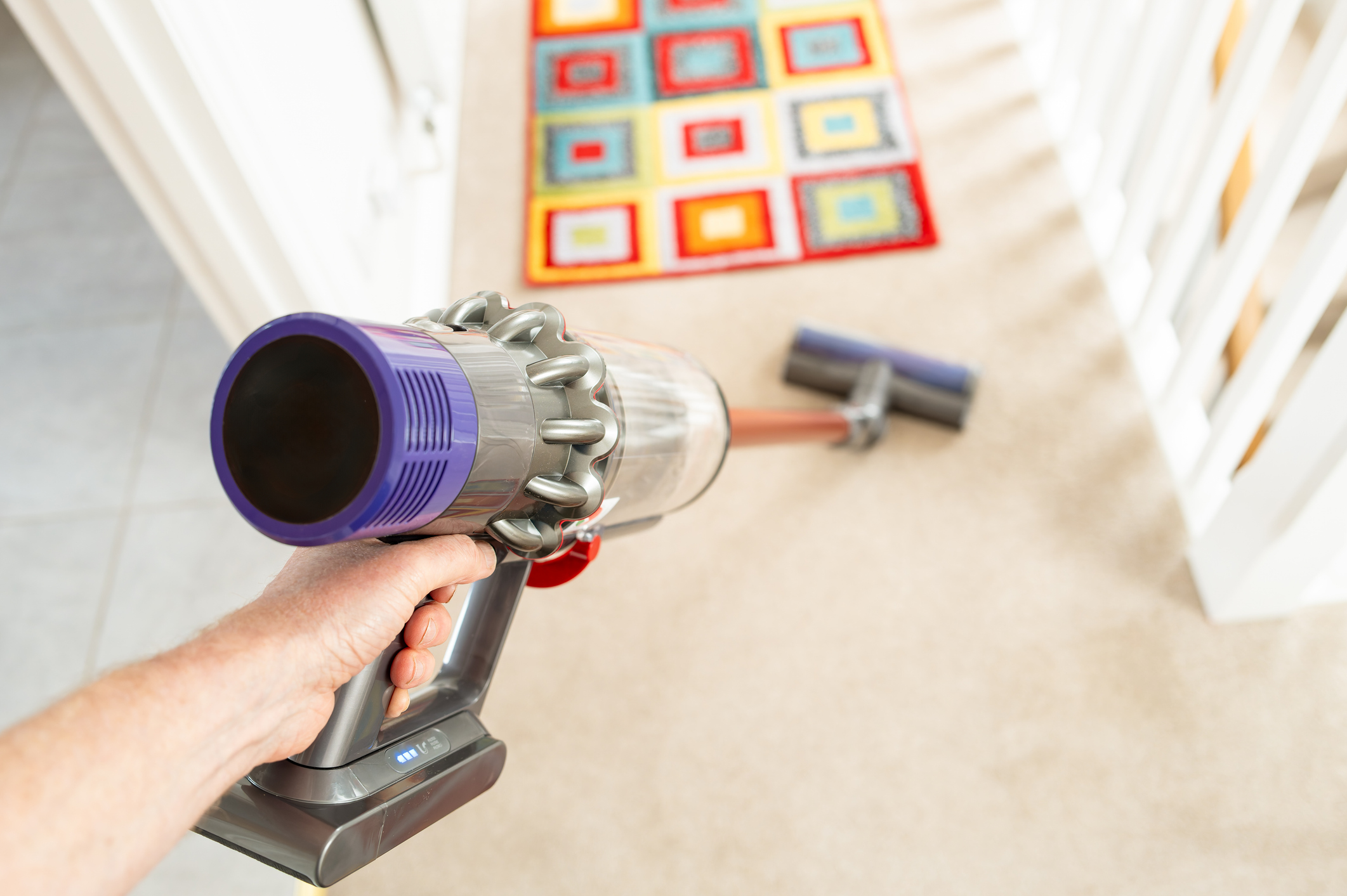 A man vacuuming the carpet.