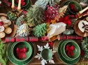 Stock photo shows a cozy and festive Christmas dining scene featuring chairs around a beautifully decorated table with glowing candles, decorated trees, and holiday decorations. The table is set with elegant place settings, placemats, and seasonal food