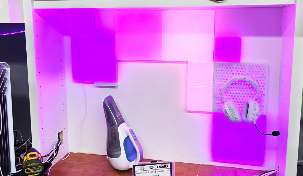 Installing a Nanoleaf blocks kit behind a desk.