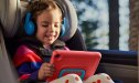 Child in carseat playing on the Amazon Fire 7 Kid's Tablet
