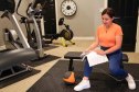 Person in gym using heating pad for cramps