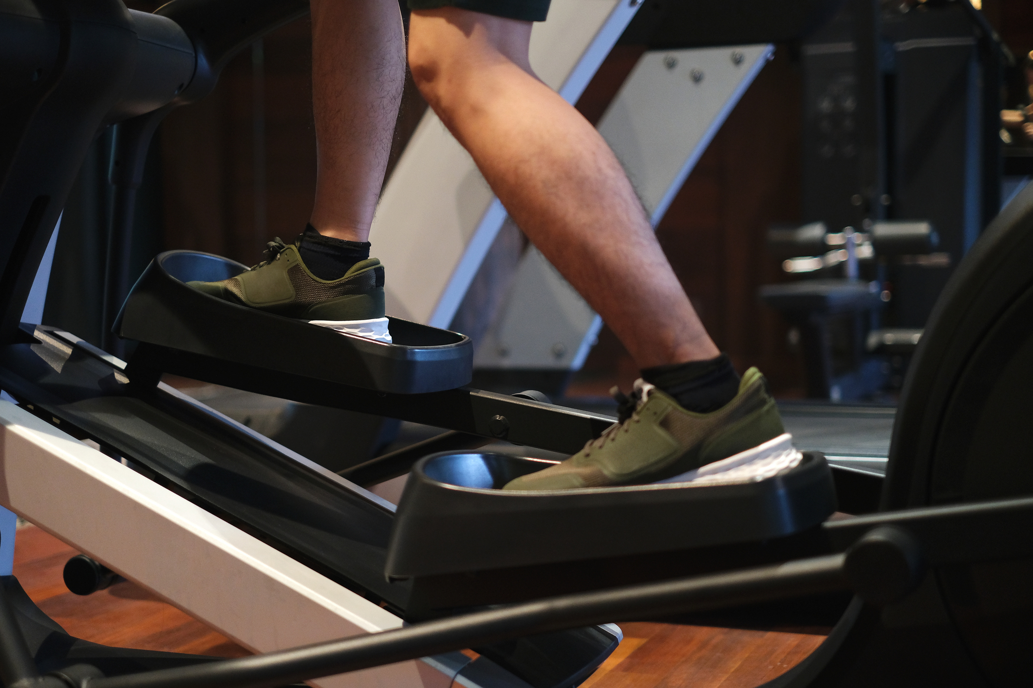Close up shot of a person on a stair master machine at a gym