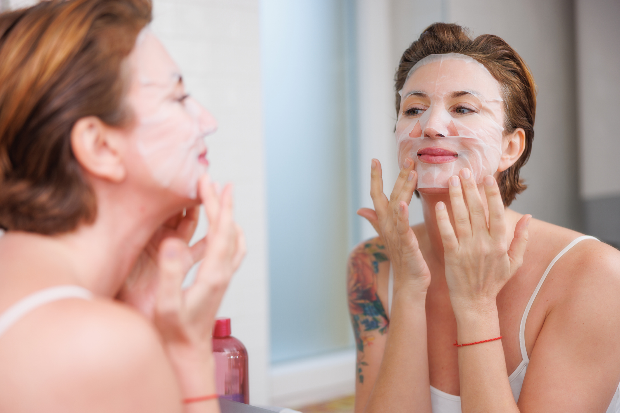 Portrait of a middle-aged woman doing her morning skin care routine.
