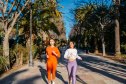 Two beautiful female friends jogging outdoors in Málaga in Spain.