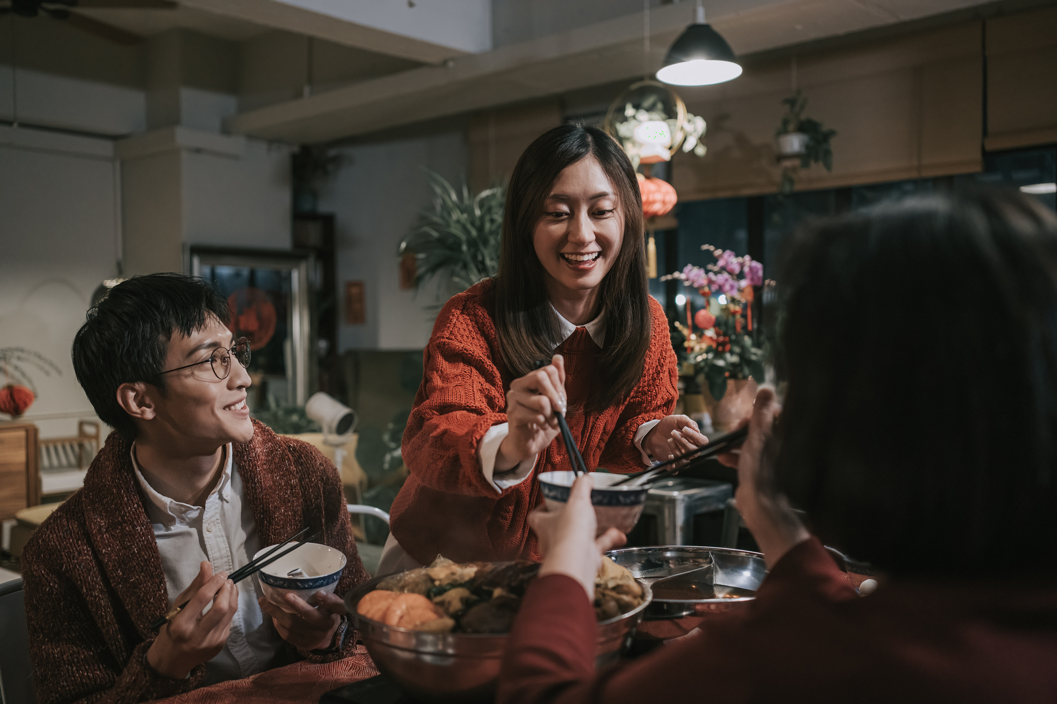 Daughter in law passing food to mother in law during Chinese New Year