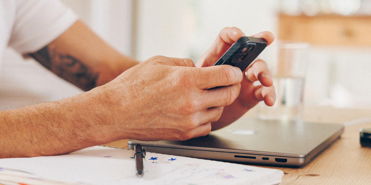 man holding phone with Monarch Money app
