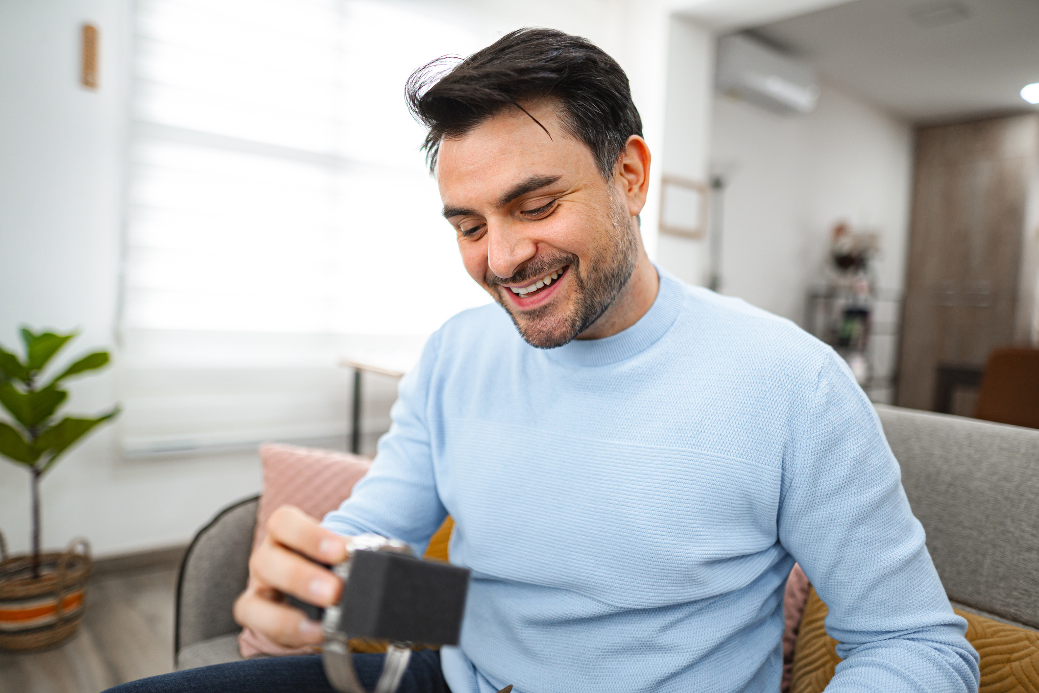 Excited Caucasian man looking at his new watch