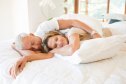 Happy mature couple lying together on a bed