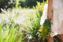 Woman carrying flowers in garden