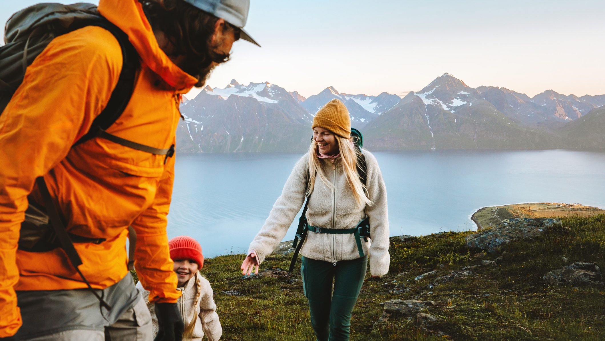 Family hiking together active travel lifestyle - mother, father, and child in mountains adventure tour in Norway, parents and kid on summer vacations outdoor, healthy lifestyle tourism, happy moments