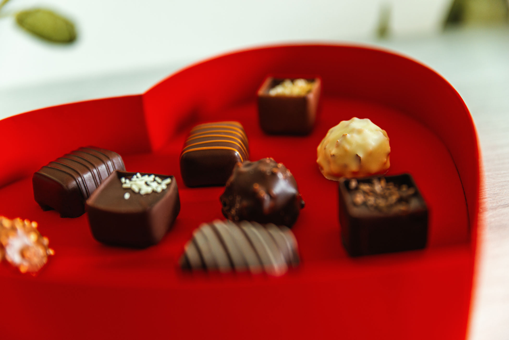 Assorted chocolate candies in heart-shaped box