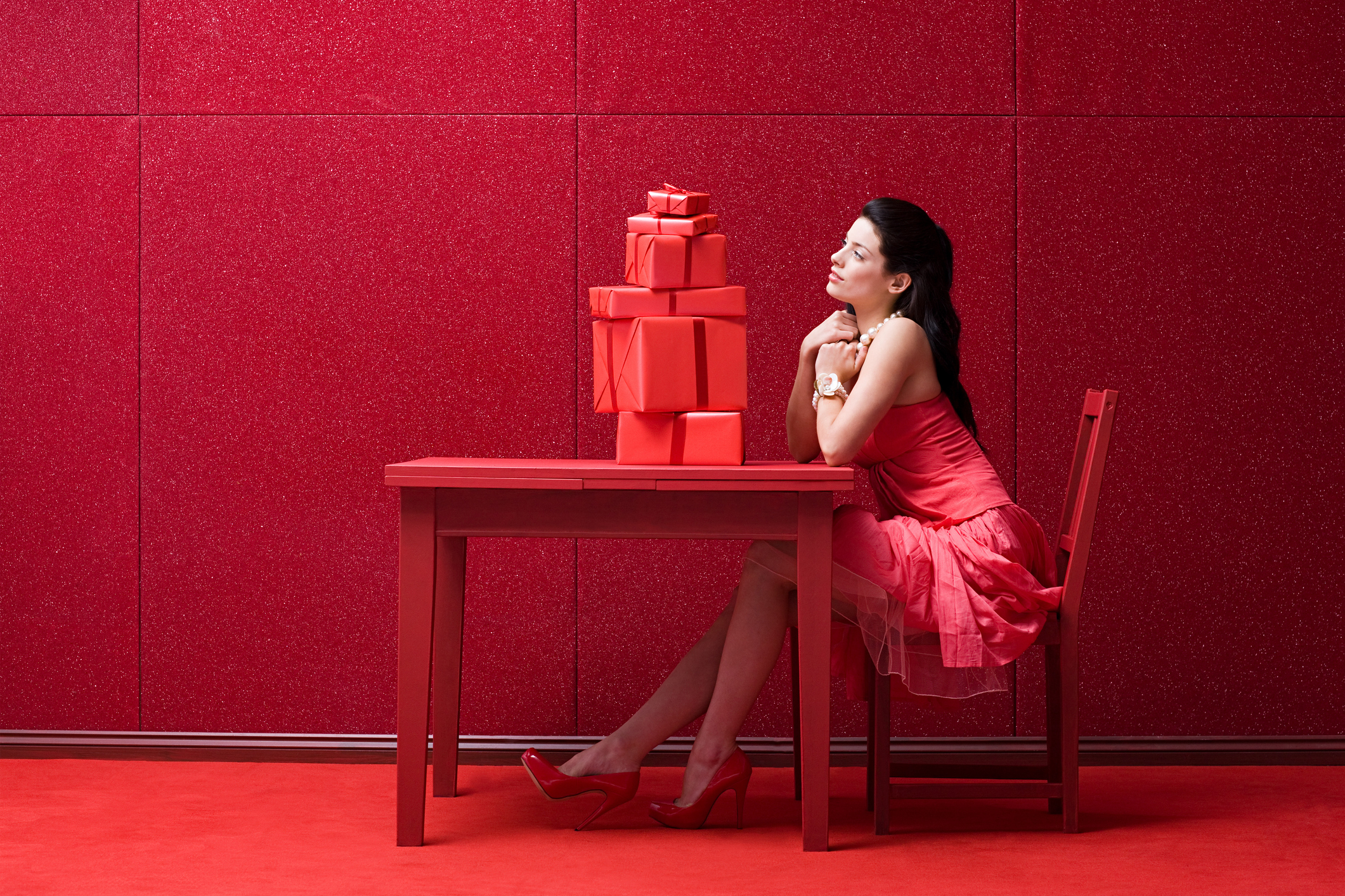 Woman in red room with gifts