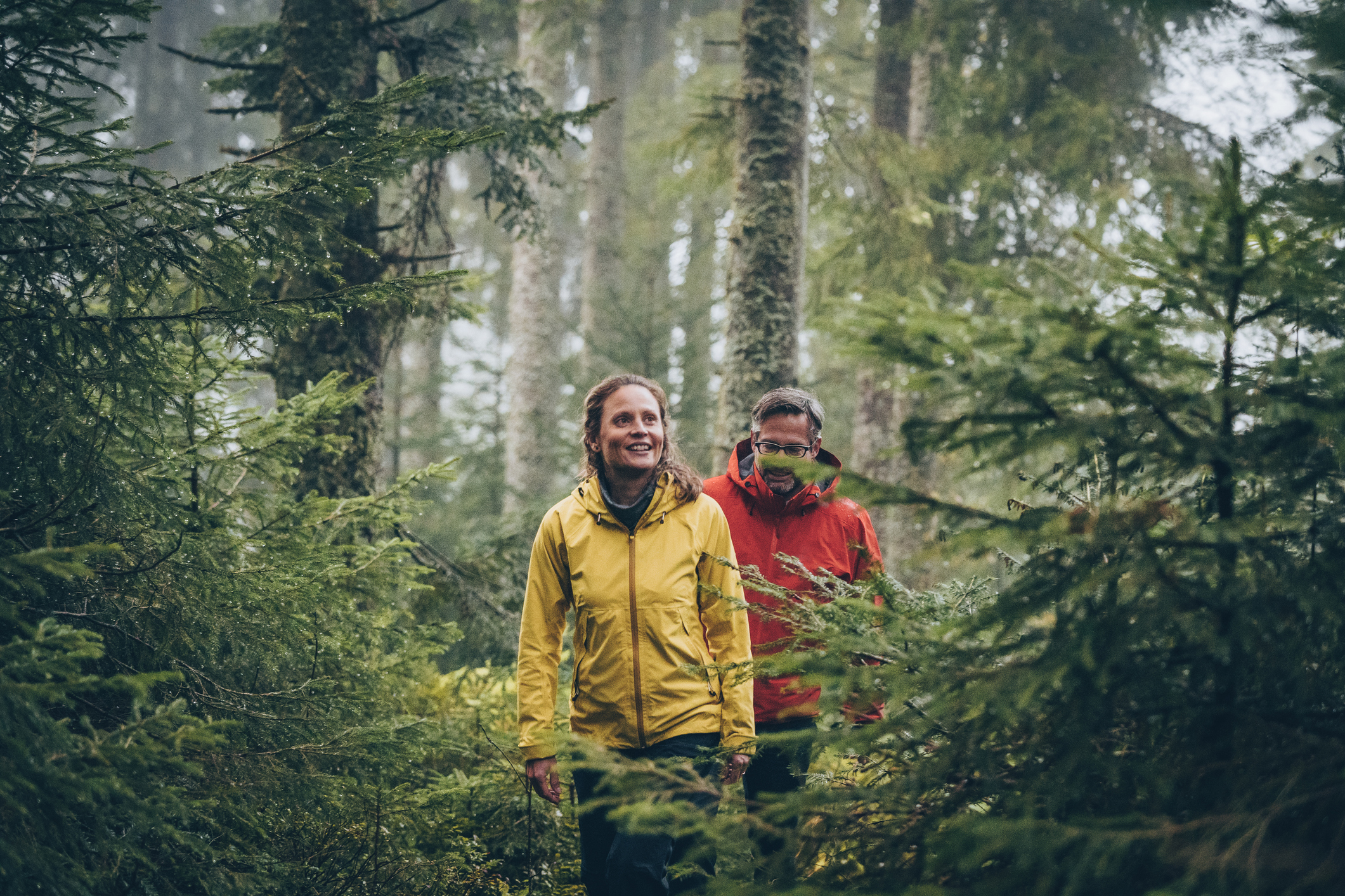 Couple hiking in the best rain gear for spring
