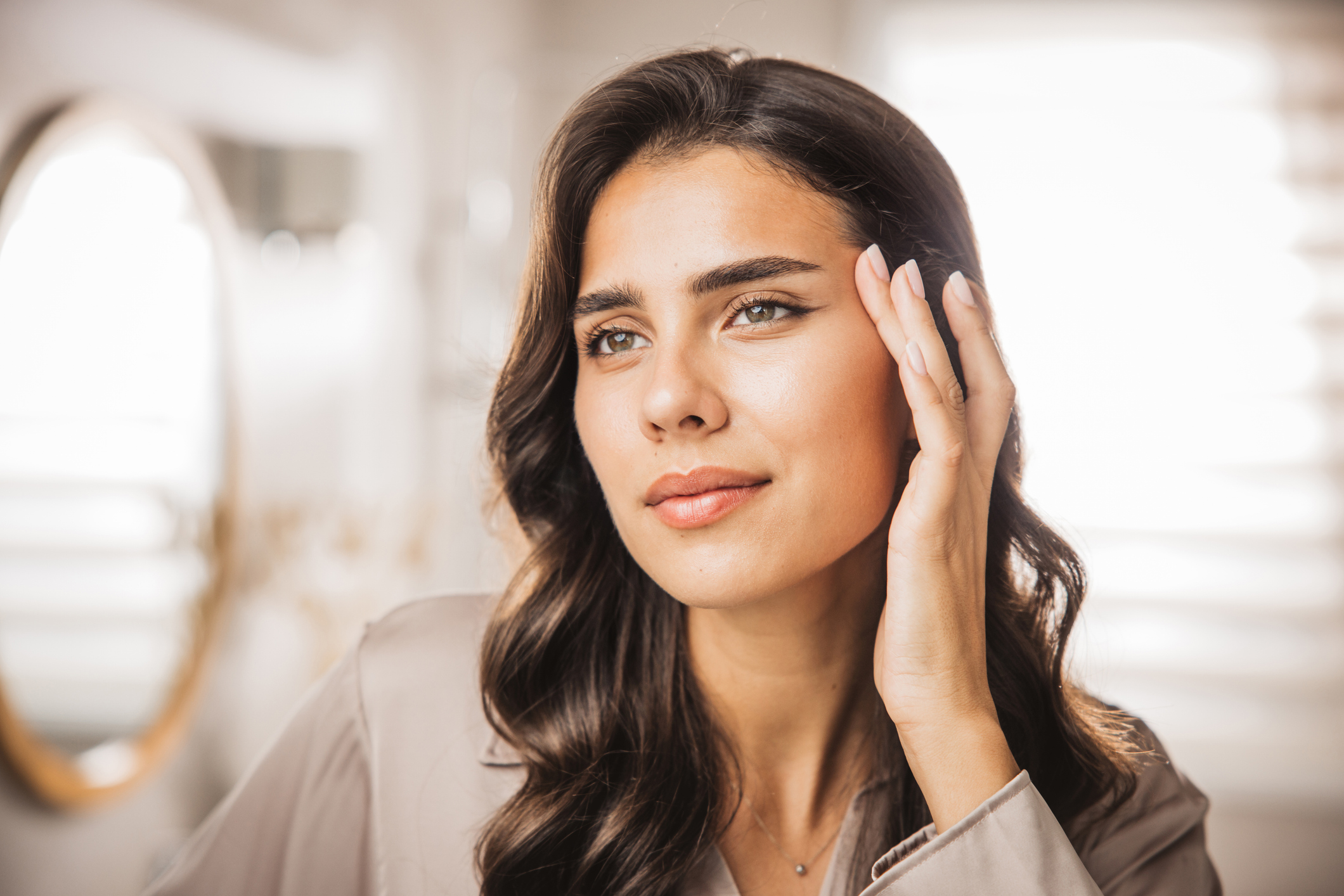 Portrait of young woman with smooth face skin having morning routine in bathroom.