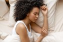 Young woman enjoying a restful sleep in her comfortable bed, embracing the tranquility of a peaceful morning