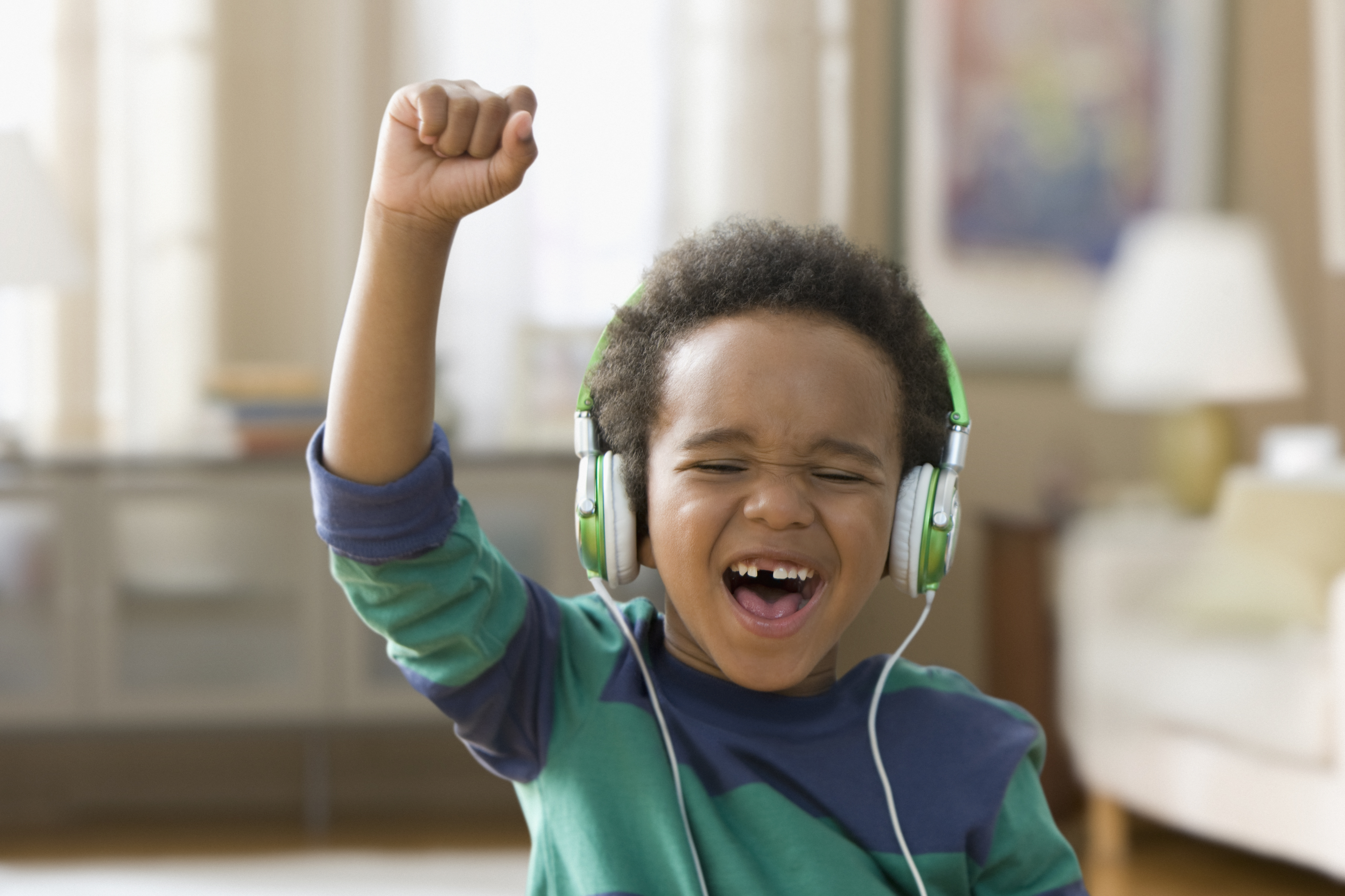 Young kid listening to music on headphones