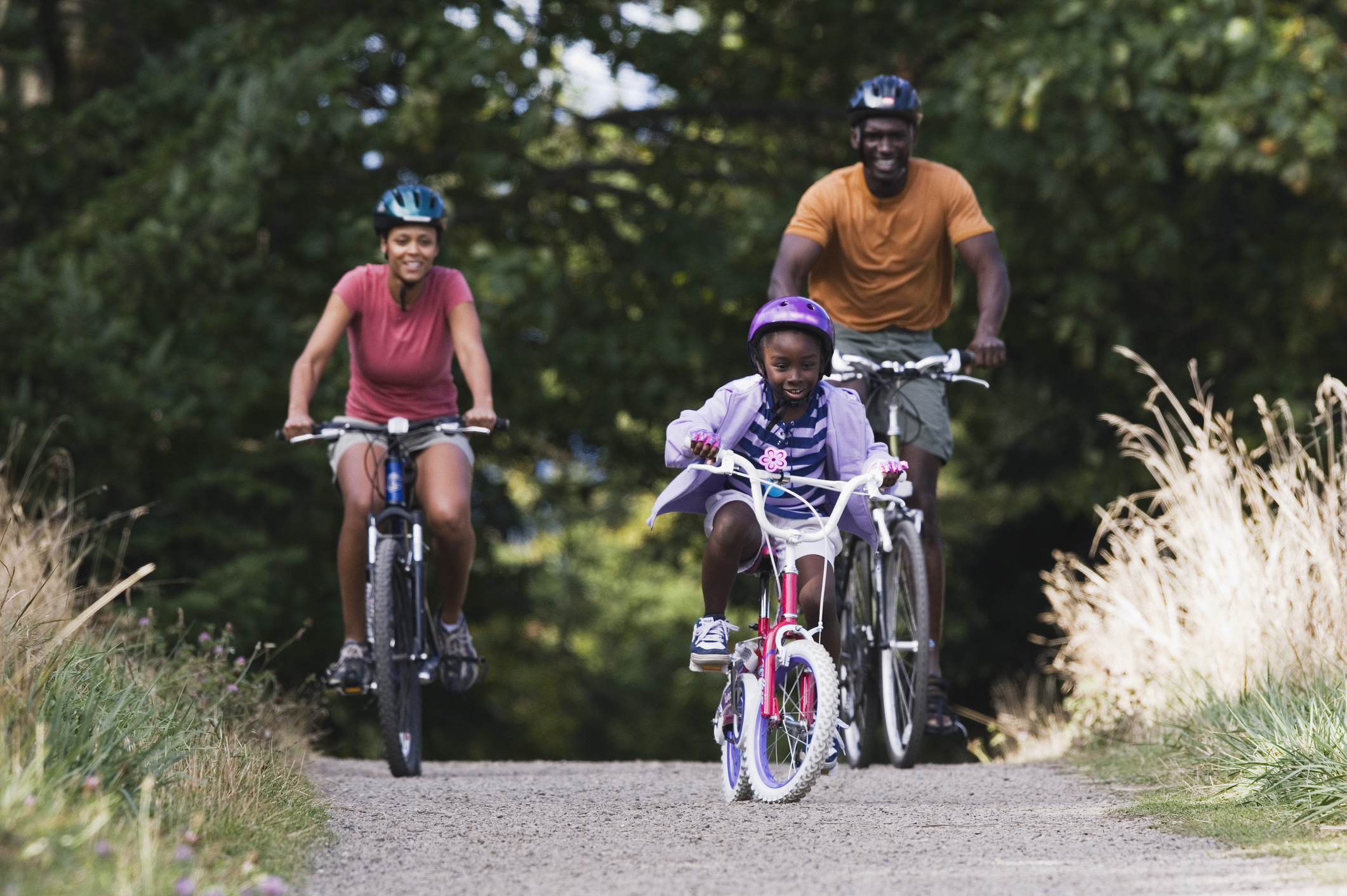Family biking on gravel path