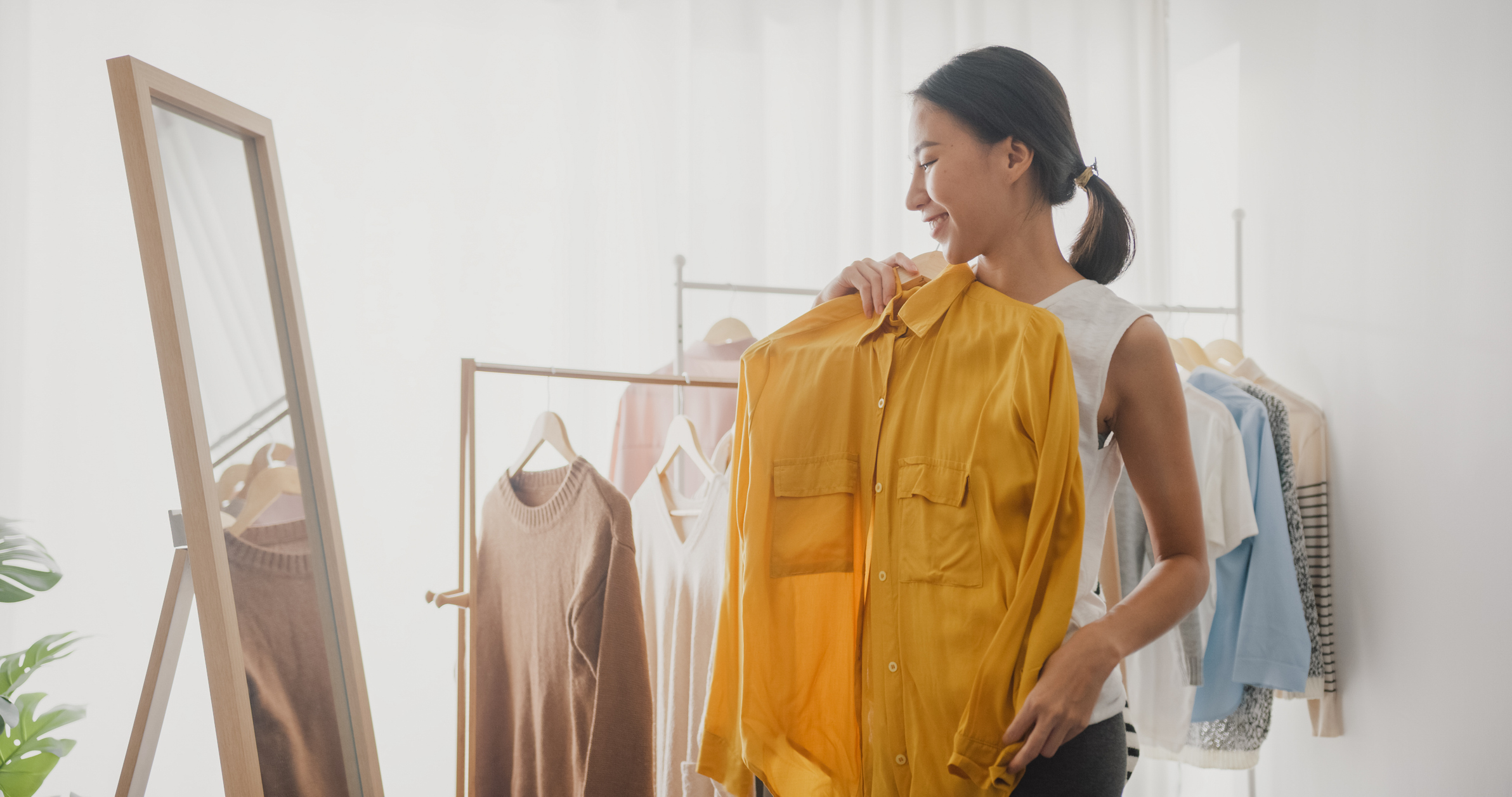 woman choosing clothes on clothes rack