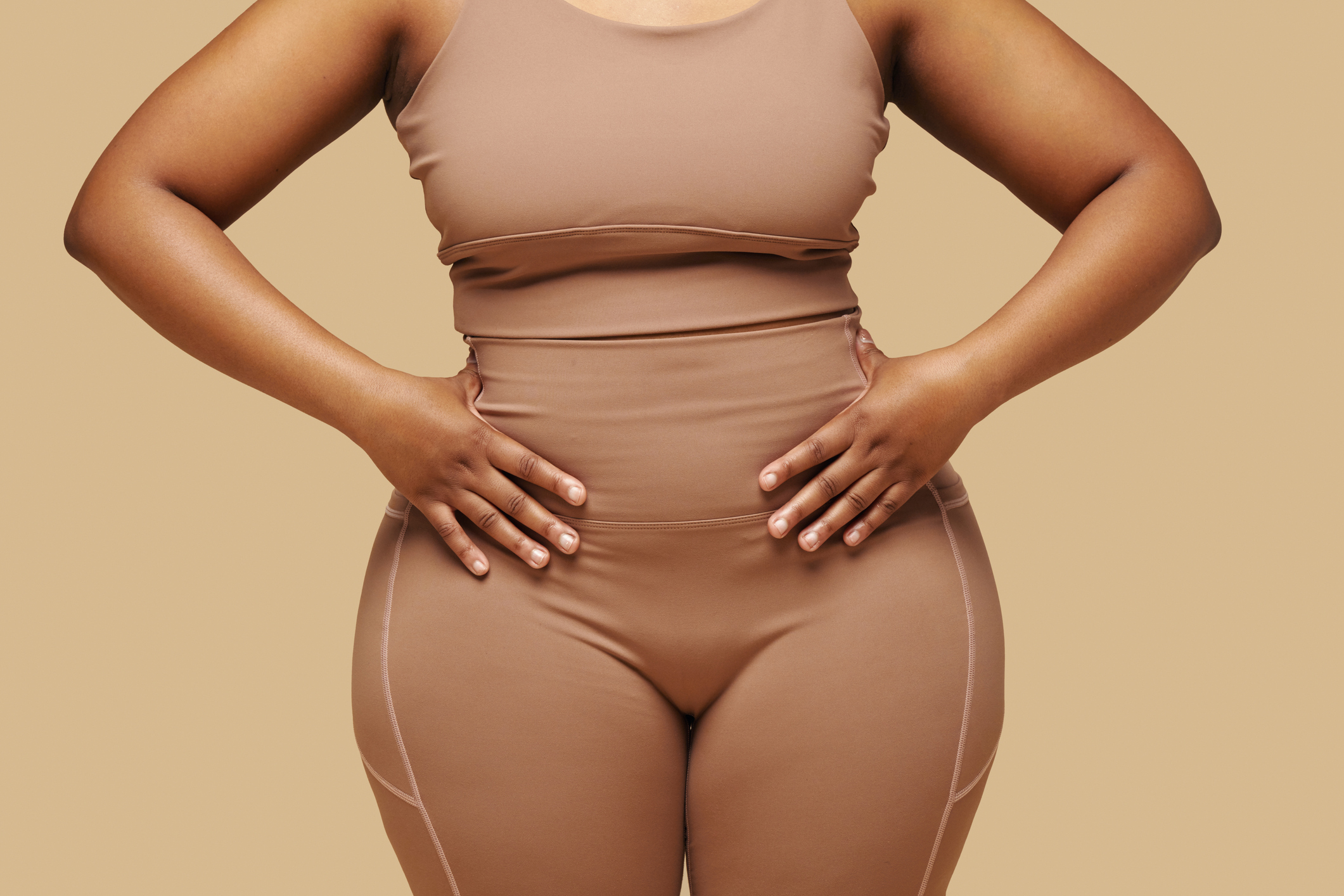 woman wearing shapewear and putting hands on waist
