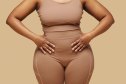 woman wearing shapewear and putting hands on waist
