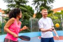 Team playing pickelball in an outdoor court