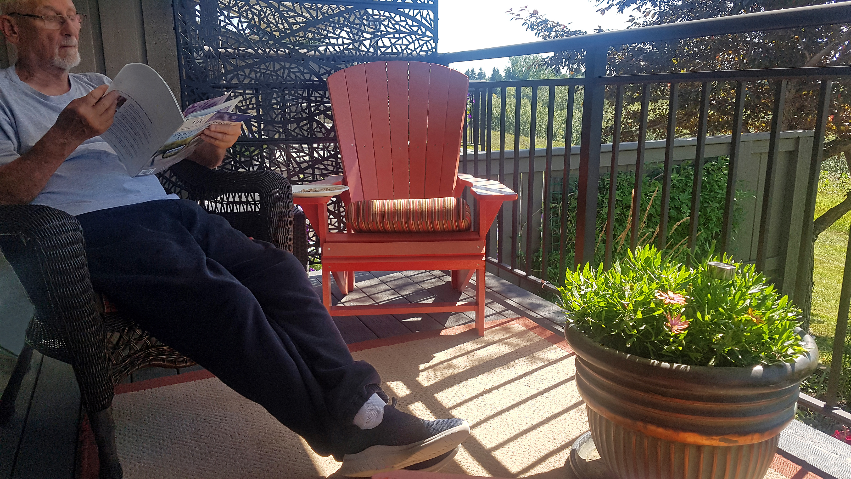 Senior Man Relaxing On Deck Reading Magazine