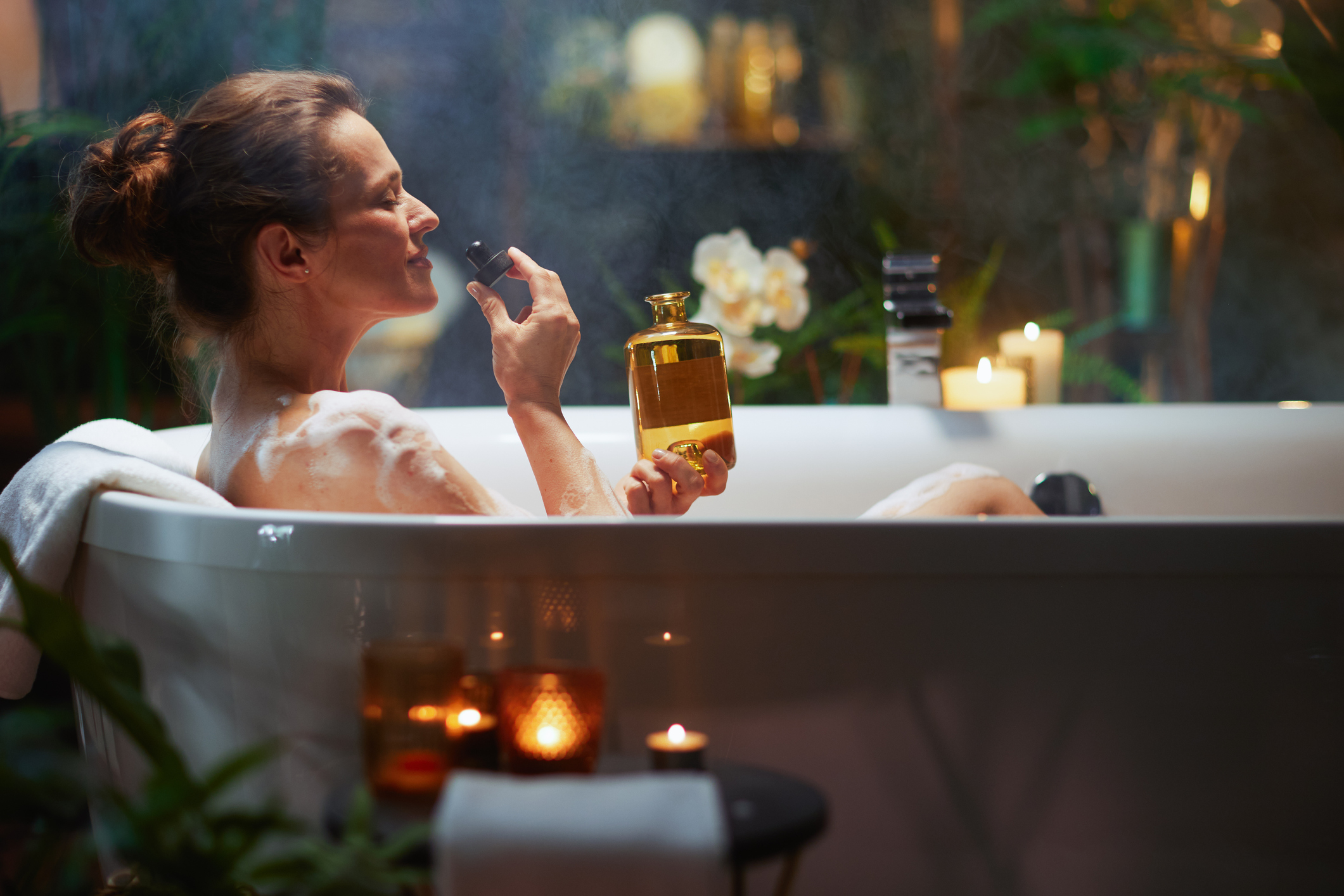 A woman enjoys a luxurious bubble bath, home spa experience