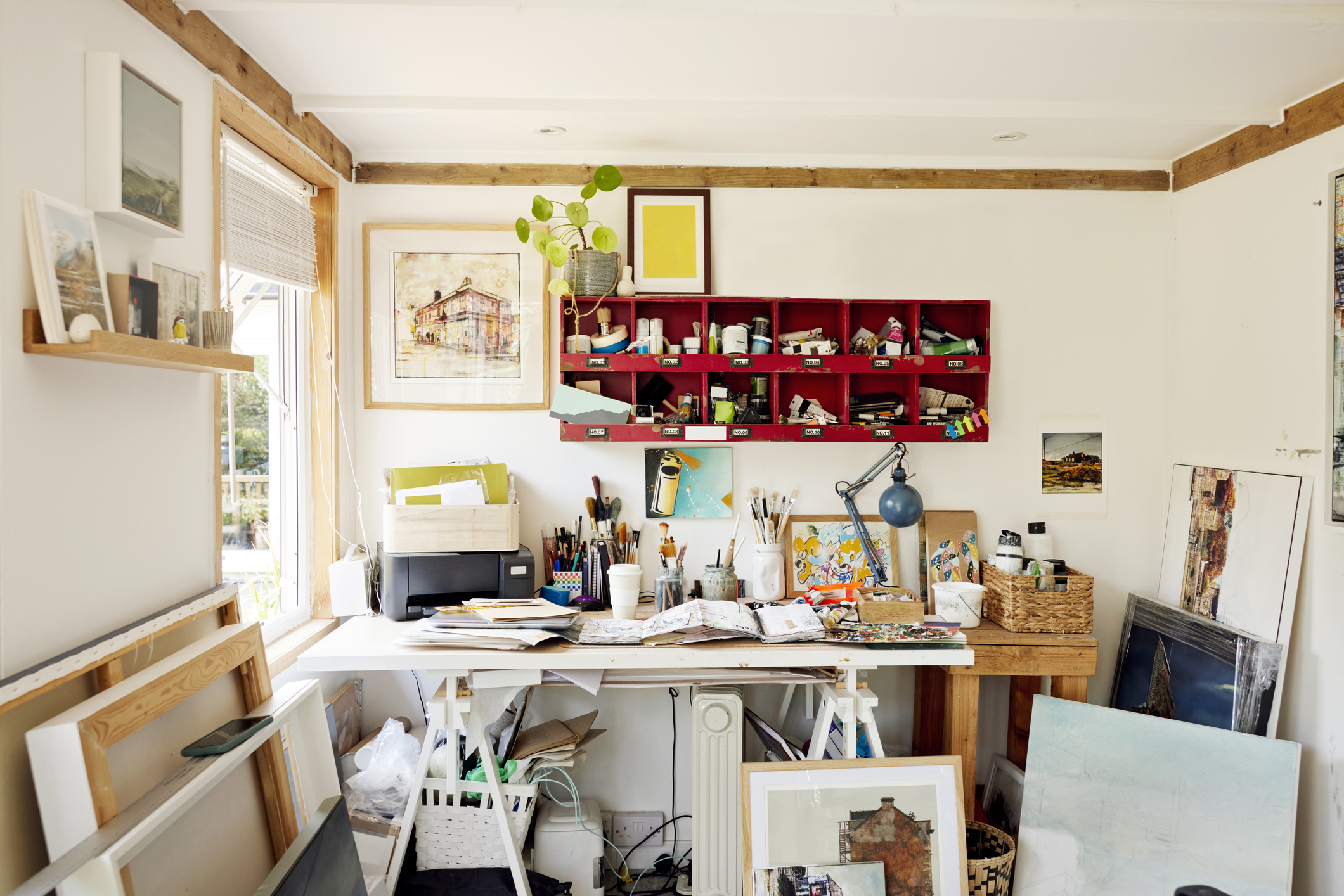 Desk in artist studio with painting supplies from the Blick overstock liquidation sale