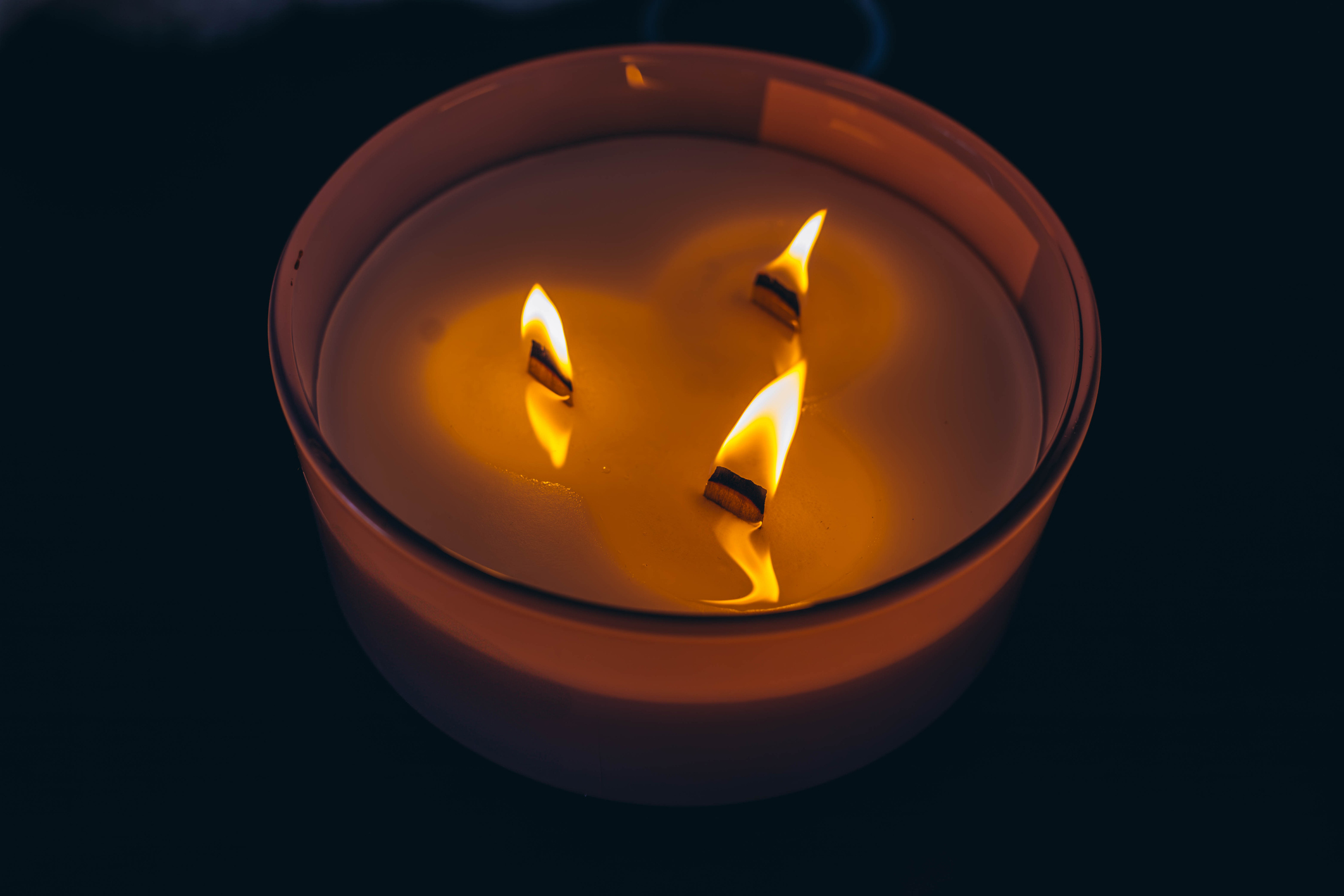 Three-wick candle symbolizing release and atmosphere of calm and serenity. High quality photo