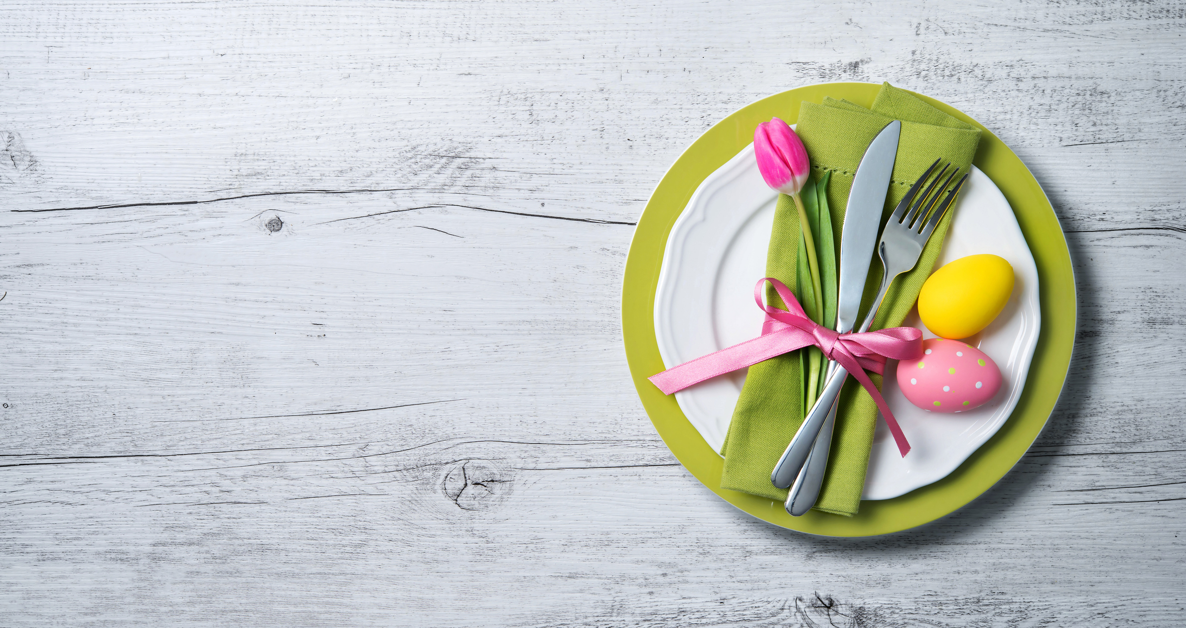 Easter table setting from Amazon's last-minute sale with spring flowers and cutlery. Holidays background